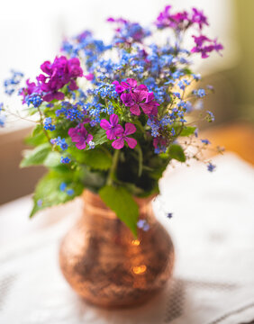Flowers from the field in a copper vase