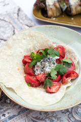 Tomato and Fresh Cheese Salad with Cilantro, Mint and Black Salt Flakes Served on Flatbread
