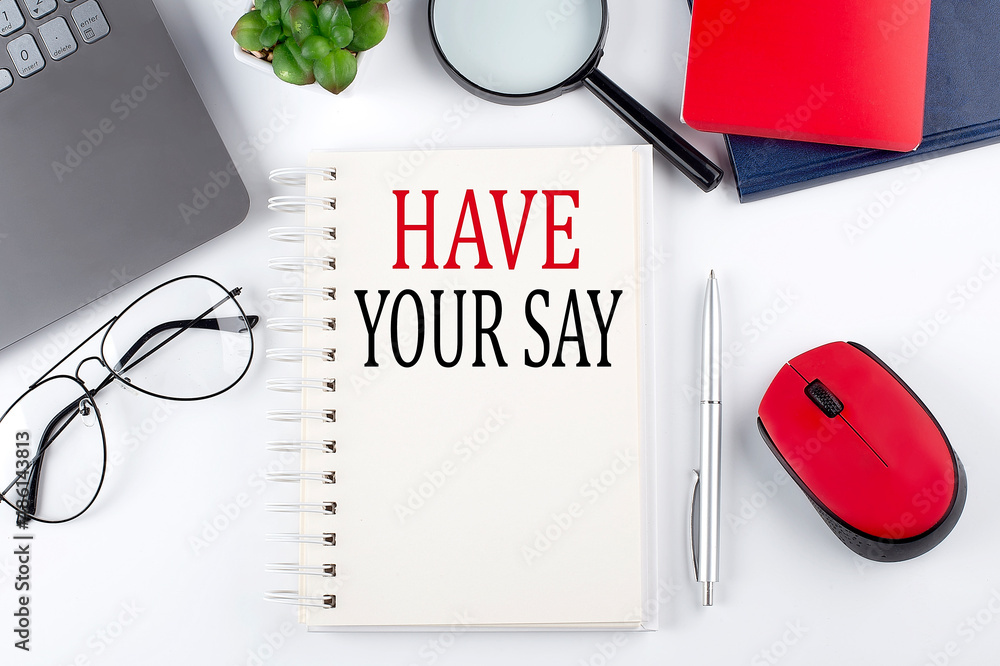 Fototapete HAVE YOUR SAY text on a notepad with laptop on the white background