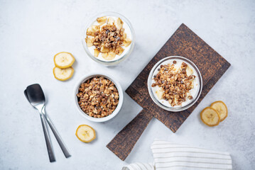 Banana Greek yogurt chocolate granola parfait in a glass