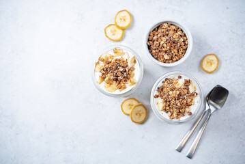 Banana Greek yogurt chocolate granola parfait in a glass