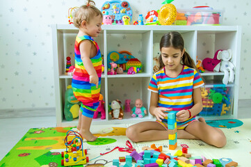 Fototapeta premium Children play together in the playroom. Selective focus.