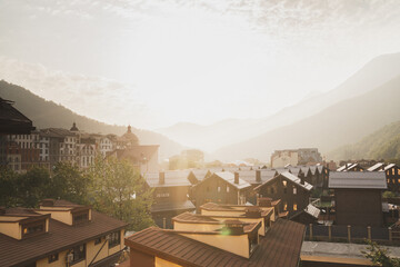 Beautiful view of the village in the mountains. Setting sun in the mountains. Warm and beautiful picture for the background