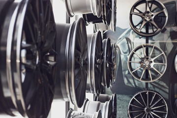 car alloy wheels in the store, blurred background. Repair and replacement of car rims
