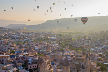 Hot air balloons above Goreme village in Cappadocia, Turkey