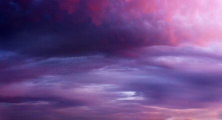 Naklejka na ściany i meble Dramatic sunset sky background with dark clouds. Natural background. Soft focus.