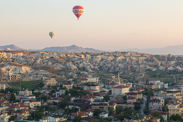 GOREME, TURKEY - JULY 21, 2019: Hot air balloons above Goreme village in Cappadocia, Turkey
