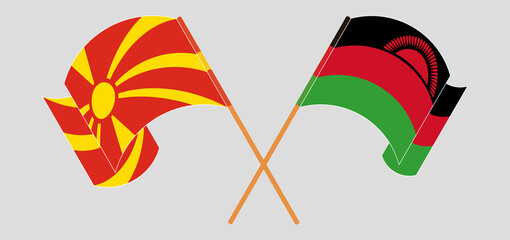 Crossed and waving flags of North Macedonia and Malawi
