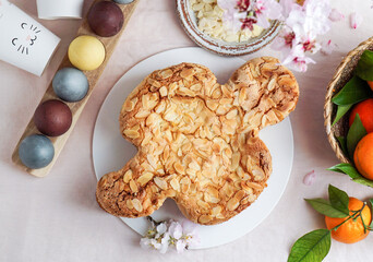 Colomba - traditional italian easter dove cake with glaze, macaranage, almonds