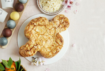 Colomba - traditional italian easter dove cake with glaze, macaranage, almonds