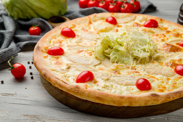 Pizza Caesar on plate on grey wooden table macro close up