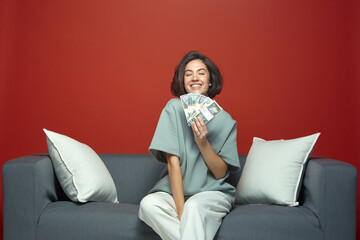 Successful rich young girl holding money cash smiling, showing banknotes enjoy financial success,...