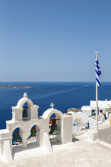 Santorini island holidays in Greece travel traveling Oia town Mediterranean Sea and church portrait...