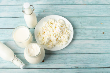 sweet cream in a jar, milk, cottage cheese on a blue background. milk products