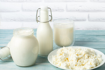 sweet cream in a jar, milk, cottage cheese on a blue background. milk products