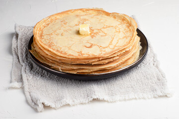 A stack of delicious pancakes on a white background, Russian cuisine.