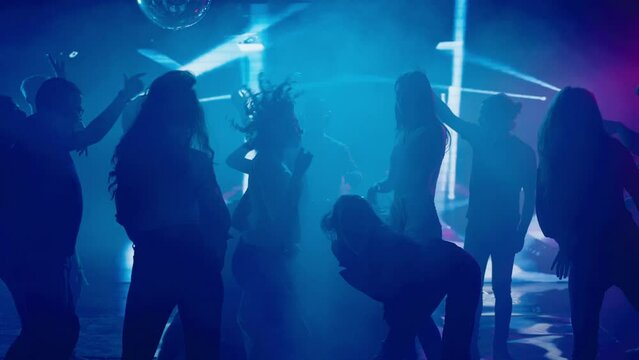 Full dancing floor in club, young people enjoying evening party. Nightlife, modern music and entertainment concept.