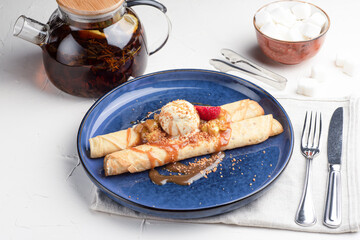 Pancakes with ice cream, sweet pancakes on a white background, Russian cuisine