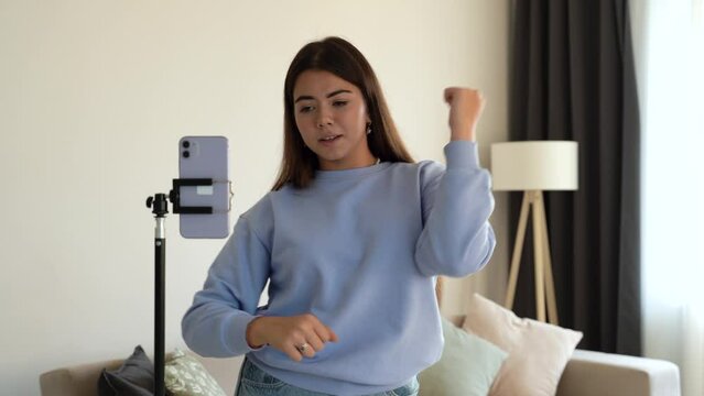 Teenager girl shooting dancing at home, when making video for social media, stories hip hop popular trandy dance, students at home make content for video-focused social networking service. 4k footage