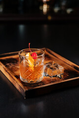 Negroni cocktail with lemon zest, canned cherries and a block of ice. Side of ice. Good choice for the weekend.