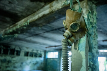 A gas mask for children hanging from the ceiling at an abandoned classroom in Pripyat, Ukraine