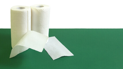 Rolls of paper towels on a green table. Economical and regular towel size. Economical and regular towel size.