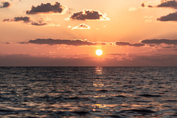 Beautiful winter sunset in Cyprus. Orange colors of the low sun in the Mediterranean Sea.