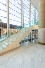 Bench and staircase. Abstract fragment of the architecture of modern lobby, hallway of the luxury hotel, shopping mall, business center in Vancouver, Canada. Interior design.
