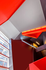 Painted in red. Abstract fragment of the architecture of modern lobby, hallway of the luxury hotel, shopping mall, business center in Vancouver, Canada. Interior design.
