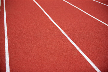Fototapeta premium red running track on athletic stadium