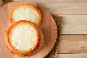 Homemade buns with cottage cheese on wooden background. Gluten free pastries.