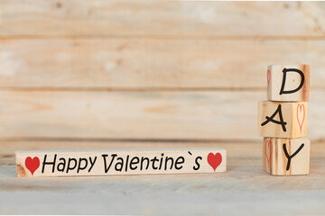 wooden blocks with the phrase happy valentine's day, on wooden background