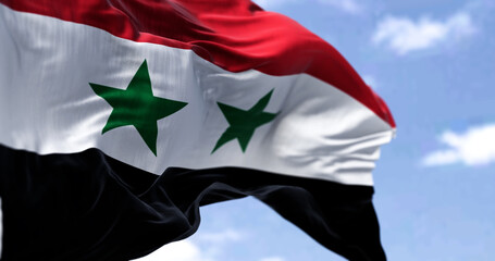 Detail of the national flag of Syria waving in the wind on a clear day