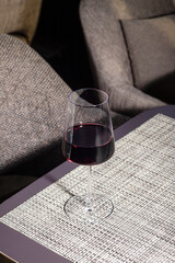 a glass of red wine on the table.