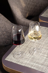 a glass of white and red wine on the table