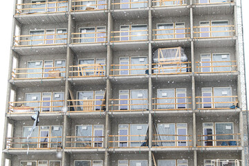 Worksite, unfinished apartment building. Construction site.