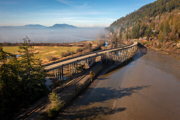 Fototapeta na wymiar Aerial View of Chuckanut Drive and the Blanchard Bridge in the Skagit Valley. Chuckanut Drive is Washington State's original scenic byway and was completed in 1896 and follows Samish Bay to Bellingham