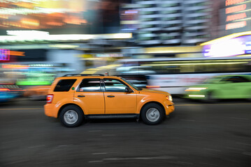 Quick pan of a yellow taxi passing through the Times Square area in NYC, USA