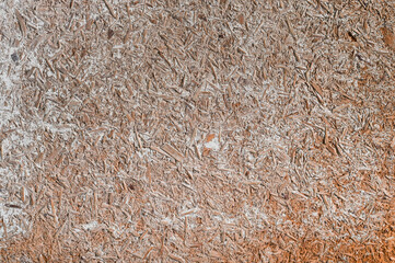 chipboard with white paint spots. the texture of a sheet of wood chips.