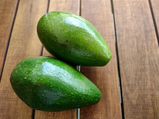 Avocado on a dark wooden background. dyeing. selective focus, rustic table 