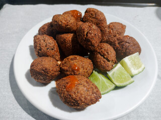 Kibbeh is a dish made with ground beef originating in the Middle East. Fried snack a typical dish of the Brazilian popular party (kibe). Much appreciated, served with Tahiti lime and chili sauce 