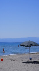Fototapeta na wymiar Wicker umbrellas on the beach 
