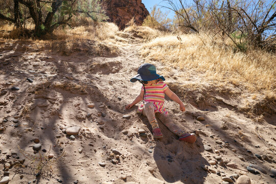 Girl playing in the sand along the Colorado River, Utah