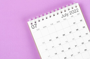 July 2022 desk calendar on light purple background.