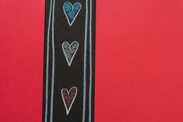 three hearts and red paper background