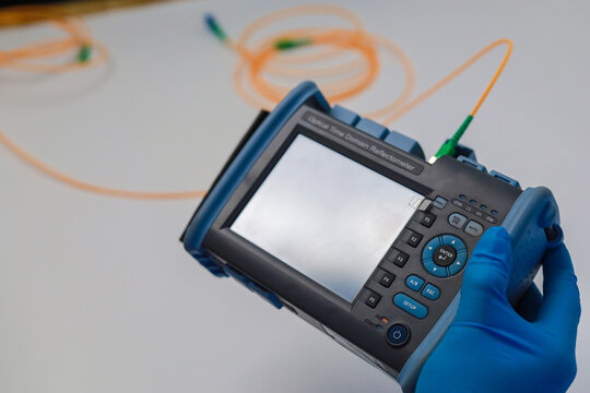 Professional testing of fiber optic connections OTDR meter. Measurement of the throughput of the optical fiber network. Expert work in the IT industry.