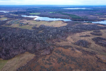 Lake in autumn season. Aerial panoramic landscape view of lake in village of Staroselye, Chashniki region, Belarus. Drone view of lake in spring. Aerial view of wetland in fall colors..