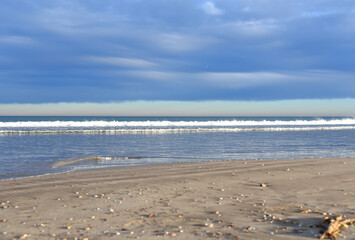 Waves at sea. Waves at sea during storm and wind. Wave from the sea goes on land to the beach....
