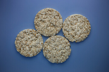 Rice buckwheat crispbread on isolated blue background top view