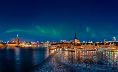 city at night with aurora